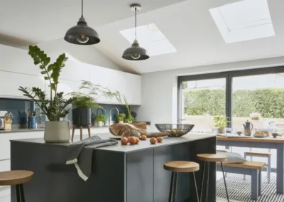 A modern kitchen with stools and a skylight.